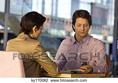 Stock Image - Businesswoman and a businessman in a meeting. Fotosearch