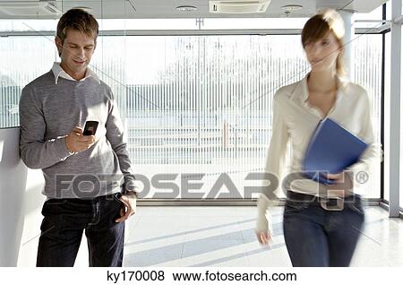 Businesswoman walking beside a businessman at an airport View Large Photo Image Stock Photo - Businesswoman walking beside a businessman at an airport. Fotosearch