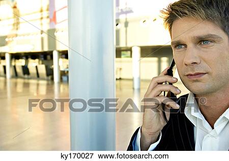 Close-up of a businessman talking on a mobile phone View Large Photo Image Stock Photo - Close-up of a businessman talking on a mobile phone. Fotosearch
