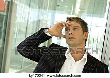 Close-up of a businessman thinking View Large Photo Image Stock Image - Close-up of a businessman thinking. Fotosearch