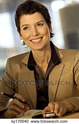 Close-up of a businesswoman smiling View Large Photo Image Stock Image - Close-up of a businesswoman smiling. Fotosearch