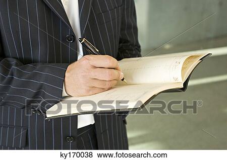 Mid section view of a businessman writing in a diary View Large Photo Image Stock Photo - Mid section view of a businessman writing in a diary. Fotosearch