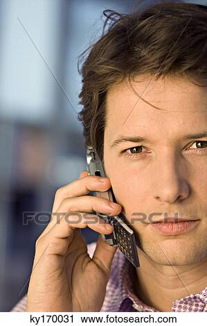Stock Image - Portrait of a businessman talking on a mobile phone. Fotosearch
