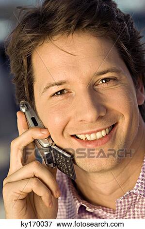 Stock Photo - Portrait of a businessman talking on a mobile phone. Fotosearch