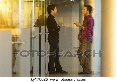 Side profile of two businessmen talking with each other View Large Photo Image Stock Photography - Side profile of two businessmen talking with each other. Fotosearch
