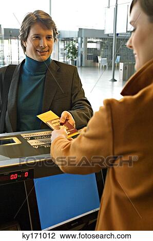 Businessman with a female check-in attendant at an airport check-in counter View Large Photo Image Stock Image - Businessman with a female check-in attendant at an airport check-in counter. Fotosearch