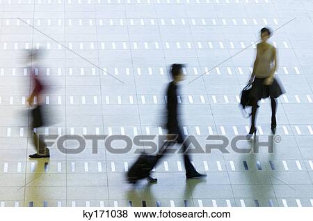 High angle view of three passengers walking at an airport lobby View Large Photo Image Stock Photo - High angle view of three passengers walking at an airport lobby. Fotosearch
