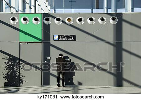 Man using cash machine at airport, rear view View Large Photo Image Stock Image - Man using cash machine at airport, rear view. Fotosearch