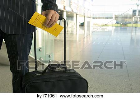 Mid section view of a businessman holding a luggage and an airplane ticket View Large Photo Image Stock Image - Mid section view of a businessman holding a luggage and an airplane ticket. Fotosearch