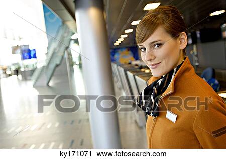 Portrait of a female airline check-in attendant smiling View Large Photo Image Stock Image - Portrait of a female airline check-in attendant smiling. Fotosearch