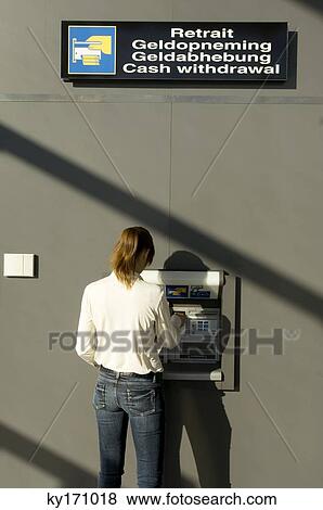 Rear view of a businesswoman using an ATM View Large Photo Image Stock Photo - Rear view of a businesswoman using an ATM. Fotosearch