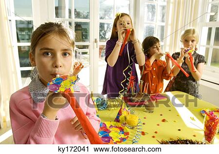 Children blowing horn blowers in a party View Large Photo Image Stock Image - Children blowing horn blowers in a party. Fotosearch