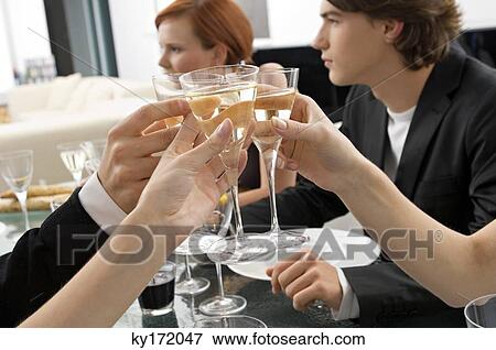 Close-up of human hands toasting with champagne at a dinner party View Large Photo Image Stock Photo - Close-up of human hands toasting with champagne at a dinner party. Fotosearch