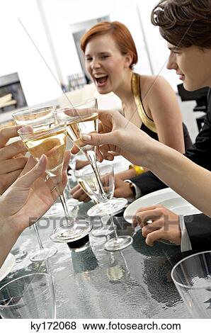 Close-up of human hands toasting with champagne at a dinner party View Large Photo Image Stock Photo - Close-up of human hands toasting with champagne at a dinner party. Fotosearch