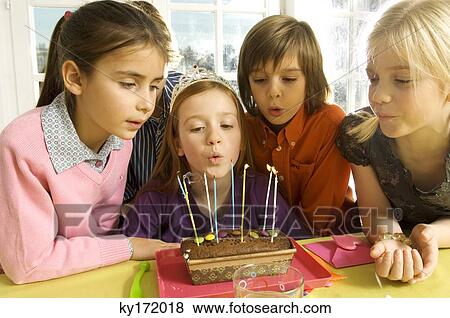 Stock Photo - Girl celebrating her birthday with her friends. Fotosearch