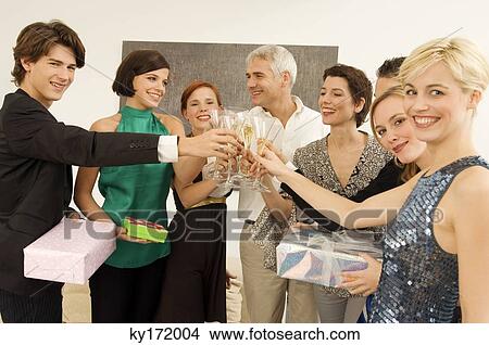 Group of people toasting with wine glasses in a party View Large Photo Image Picture - Group of people toasting with wine glasses in a party. Fotosearch