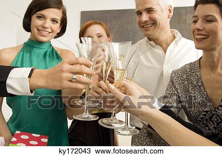 Group of people toasting with wine glasses in a party View Large Photo Image Stock Image - Group of people toasting with wine glasses in a party. Fotosearch