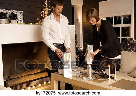 Mid adult man and a young woman celebrating Christmas View Large Photo Image Stock Photography - Mid adult man and a young woman celebrating Christmas. Fotosearch