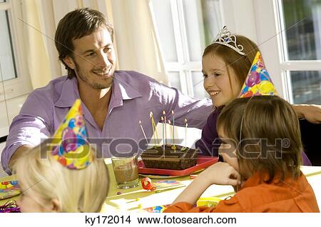 Picture - Mid adult man celebration his daughter's birthday. Fotosearch
