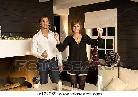 Portrait of a mid adult man and a young woman celebrating Christmas View Large Photo Image Stock Photo - Portrait of a mid adult man and a young woman celebrating Christmas. Fotosearch
