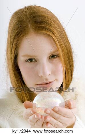 Portrait of a young woman holding a crystal ball View Large Photo Image Picture - Portrait of a young woman holding a crystal ball. Fotosearch