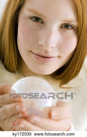 Portrait of a young woman holding a crystal ball View Large Photo Image Stock Photography - Portrait of a young woman holding a crystal ball. Fotosearch