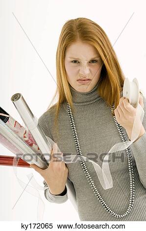 Portrait of a young woman holding rolls of wrapping papers View Large Photo Image Stock Photography - Portrait of a young woman holding rolls of wrapping papers. Fotosearch