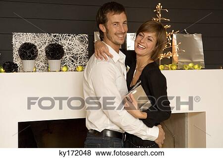 Side profile of a mid adult man embracing his wife View Large Photo Image Stock Photo - Side profile of a mid adult man embracing his wife. Fotosearch