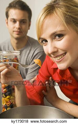 Close-up of a young woman holding pasta on a fork View Large Photo Image Stock Photo - Close-up of a young woman holding pasta on a fork. Fotosearch