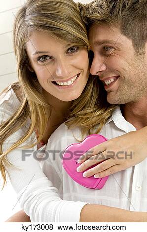 Portrait of a young woman embracing a mid adult man from behind View Large Photo Image Stock Photo - Portrait of a young woman embracing a mid adult man from behind. Fotosearch