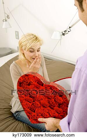 Stock Photograph Of Young Man Giving A Gift To Woman Stock Photograph Young Man Giving A Gift To Woman Fotosearch Search