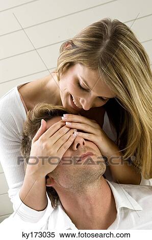 Young woman covering eyes of a mid adult man from behind View Large Photo Image Stock Photography - Young woman covering eyes of a mid adult man from behind. Fotosearch