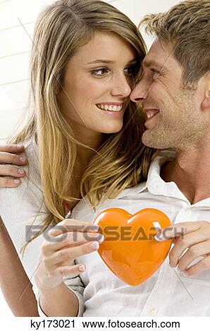 Young woman embracing a mid adult man from behind View Large Photo Image Stock Image - Young woman embracing a mid adult man from behind. Fotosearch