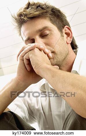 Close-up of a mid adult man with his eyes closed View Large Photo Image Stock Photo - Close-up of a mid adult man with his eyes closed. Fotosearch
