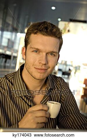 Portrait of a businessman holding a tea cup View Large Photo Image Stock Image - Portrait of a businessman holding a tea cup. Fotosearch