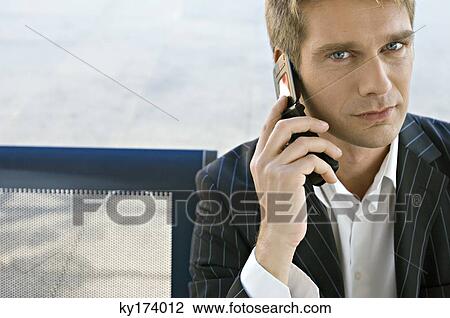 Portrait of a businessman talking on a mobile phone View Large Photo Image Stock Image - Portrait of a businessman talking on a mobile phone. Fotosearch