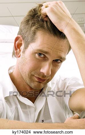 Picture - Portrait of a mid adult man looking serious. Fotosearch