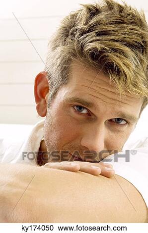 Stock Image - Portrait of a mid adult man looking serious. Fotosearch