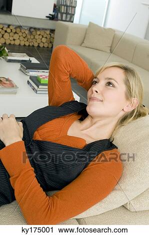 Close-up of a young woman lying on a couch and thinking View Large Photo Image Stock Image - Close-up of a young woman lying on a couch and thinking. Fotosearch