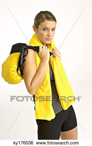 Portrait of a female boxer carrying boxing gloves on her shoulder View Large Photo Image Stock Photograph - Portrait of a female boxer carrying boxing gloves on her shoulder. Fotosearch