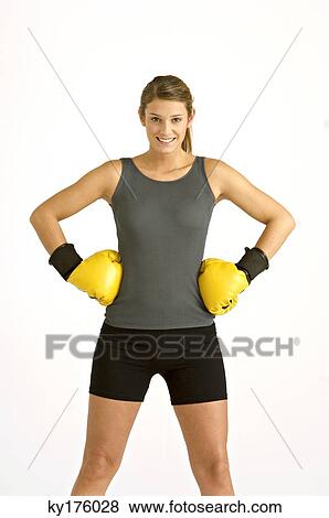 Portrait of a female boxer standing with arms akimbo and smiling View Large Photo Image Stock Photo - Portrait of a female boxer standing with arms akimbo and smiling. Fotosearch