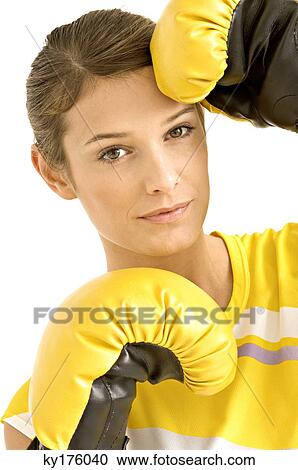 Portrait of a female boxer wearing boxing gloves View Large Photo Image Stock Image - Portrait of a female boxer wearing boxing gloves. Fotosearch