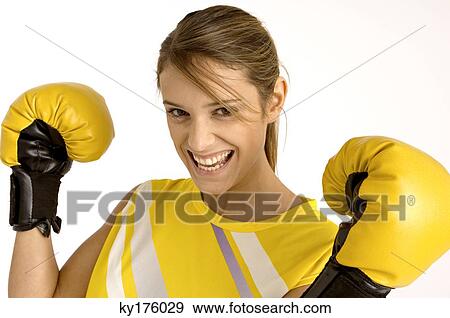Portrait of a female boxer wearing boxing gloves and smiling View Large Photo Image Stock Photo - Portrait of a female boxer wearing boxing gloves and smiling. Fotosearch