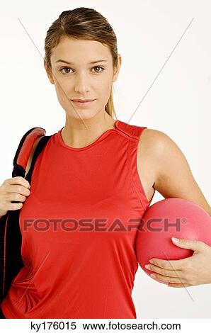 Portrait of a young woman carrying a gym bag and a ball View Large Photo Image Stock Photography - Portrait of a young woman carrying a gym bag and a ball. Fotosearch