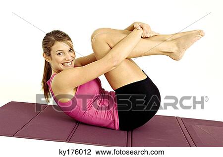 Portrait of a young woman exercising on an exercise mat View Large Photo Image Stock Image - Portrait of a young woman exercising on an exercise mat. Fotosearch