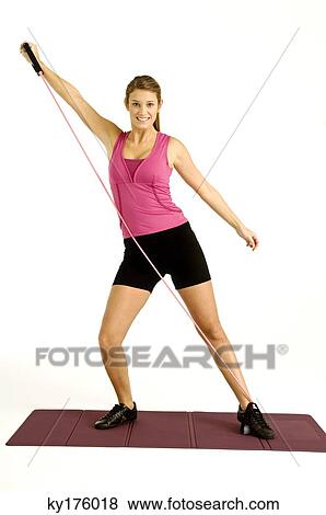 Portrait of a young woman exercising with a resistance band View Large Photo Image Stock Photo - Portrait of a young woman exercising with a resistance band. Fotosearch