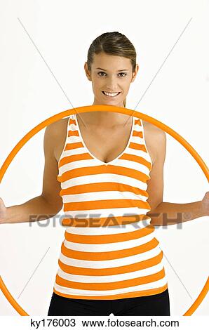 Portrait of a young woman holding a plastic hoop View Large Photo Image Stock Image - Portrait of a young woman holding a plastic hoop. Fotosearch