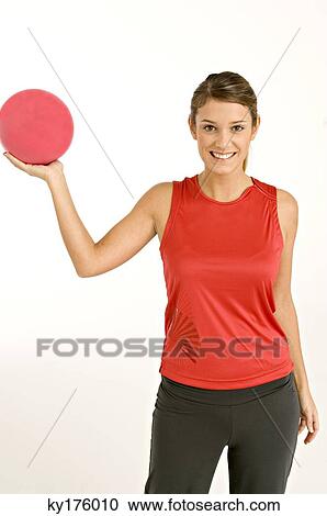 Portrait of a young woman holding a ball and smiling View Large Photo Image Stock Image - Portrait of a young woman holding a ball and smiling. Fotosearch