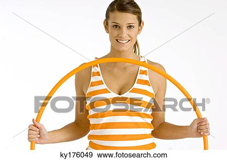 Portrait of a young woman holding a plastic hoop View Large Photo Image Stock Photo - Portrait of a young woman holding a plastic hoop. Fotosearch