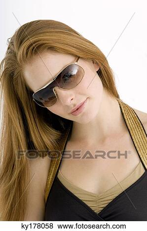 Close-up of a young woman wearing sunglasses View Large Photo Image Stock Photo - Close-up of a young woman wearing sunglasses. Fotosearch